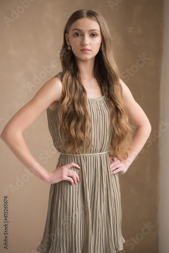 Fashion young woman wearing grey clothes posing on grey background