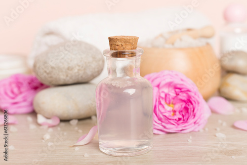 Spa composition with pink roses on wooden table