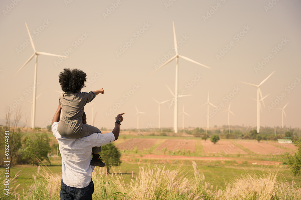 custom made wallpaper toronto digitalAfrican american family in the community with wind generators turbines, Wind turbines are alternative electricity sources, the concept of sustainable resources and Renewable energy. sunset.