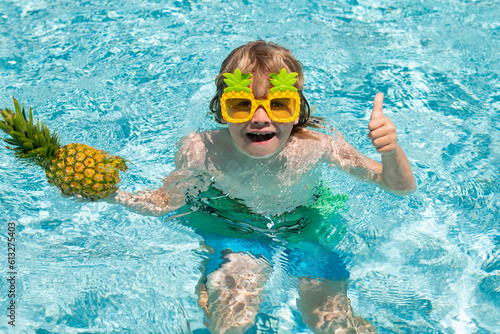 Child in swimming pool. Summer kids activity. Summer vacation. Healthy kids lifestyle.