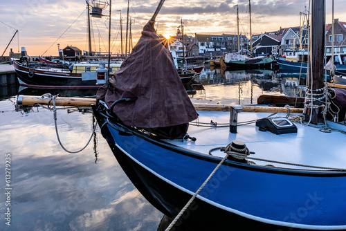 boats in the port of Urk, Netherlands at sunset photo