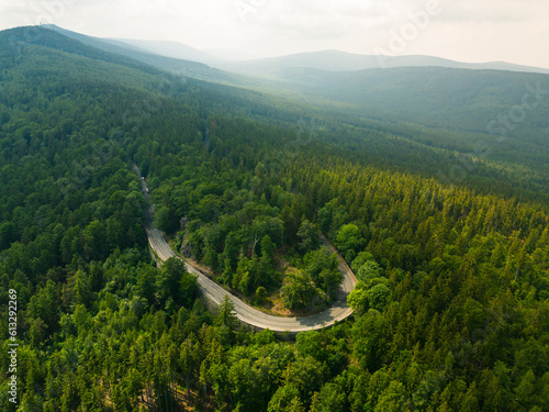 Winding mountain asphalt road. Forest around, mountains in the background. Jizera Mountains. Szklarska Poreba. Lower Silesia.