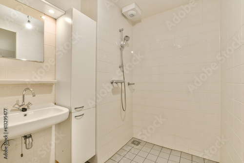 a bathroom with a sink and mirror above the shower stall in white tiled wallpapered room next to it