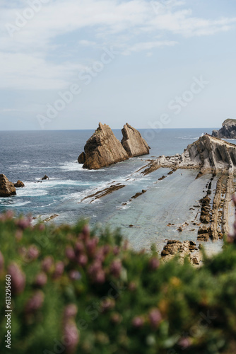 rocky coast with waves and crystal blue hour in the north of spain in europe (ID: 613295660)