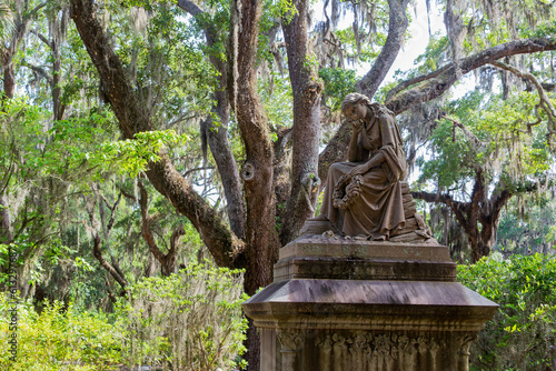 Eliza Wilhelmina Theus statute amidst the spanish moss in Bonaventure Cemetery in Savannah, Georgia.