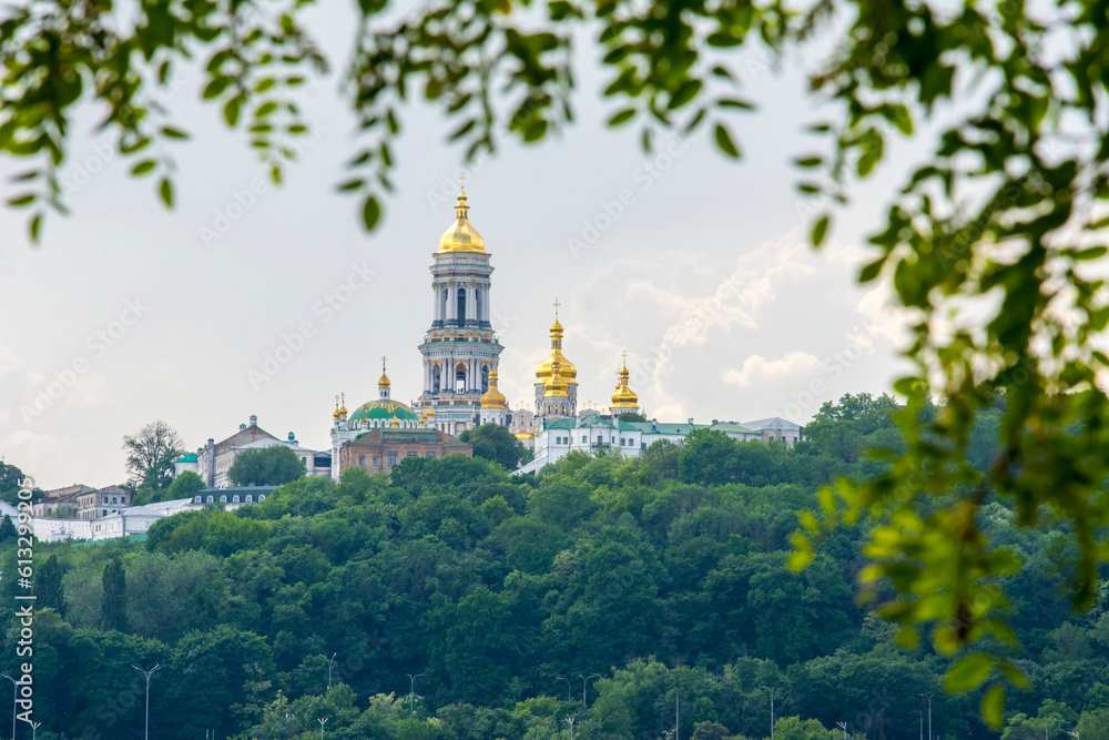 In summer, through the branches of trees, you can see the Kyiv Lavra