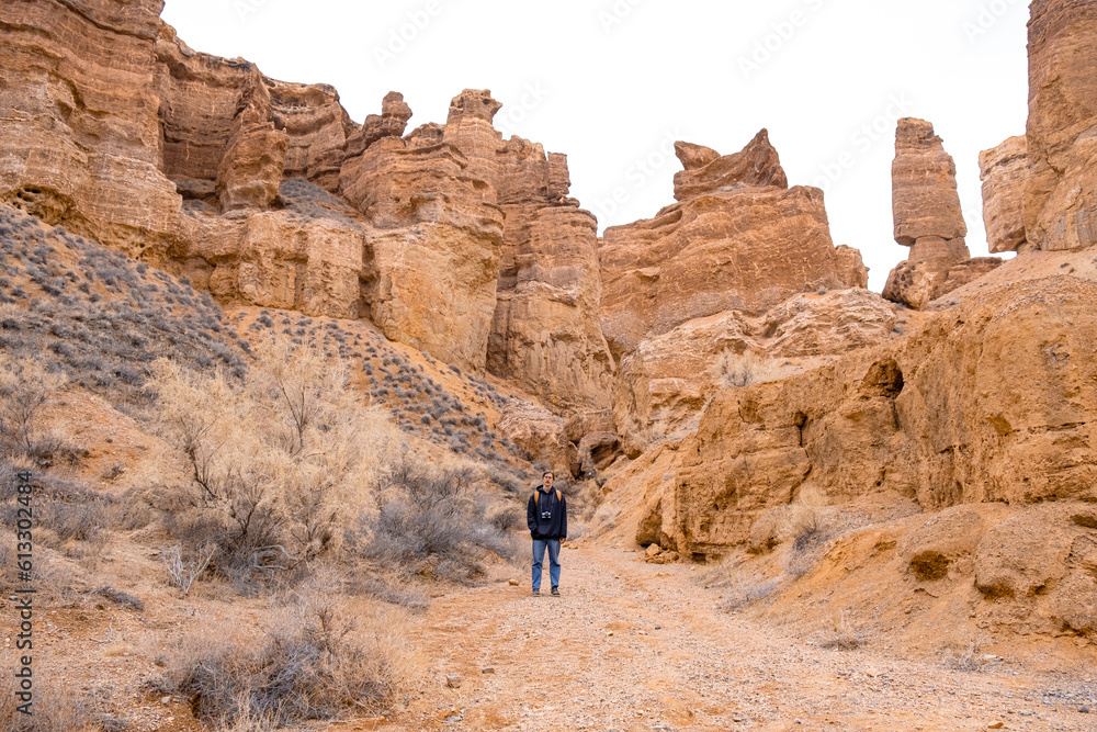  Man taking photo of a Charyn canyon in the Almaty region of Kazakhstan.