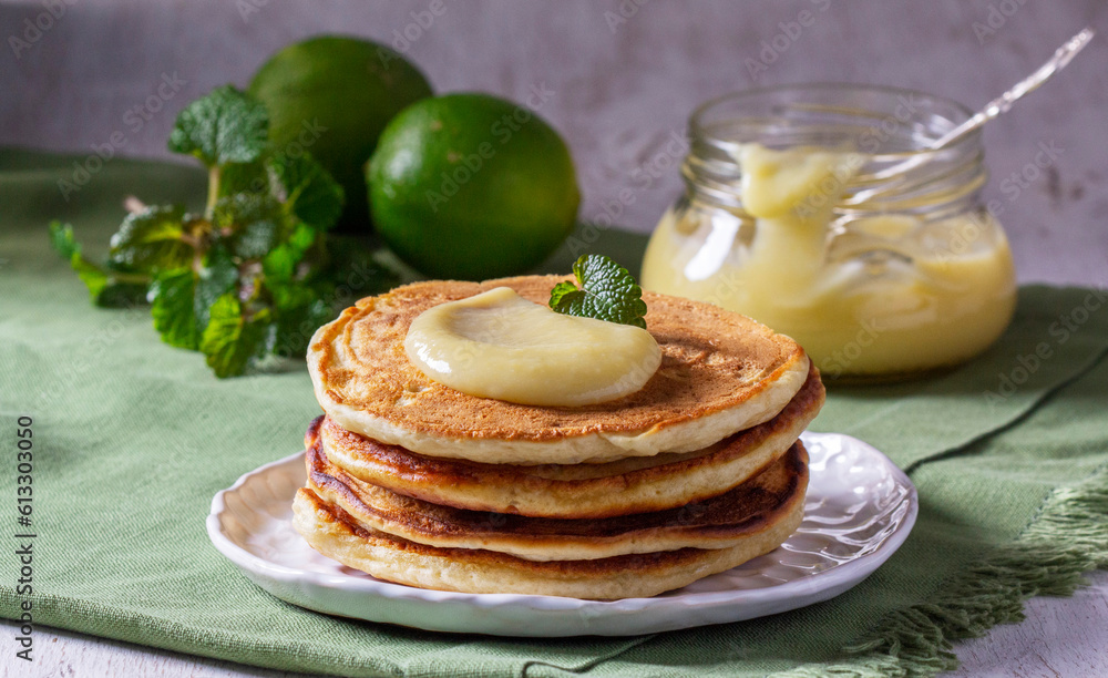Whole grain flour fritters served with lime curd on a light background. Rustic style.