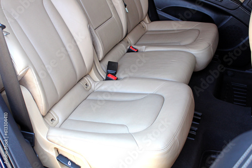 Beige leather car interior. Interior of prestige new car. Comfortable perforated beige leather rear passenger seats. Car detailing series.