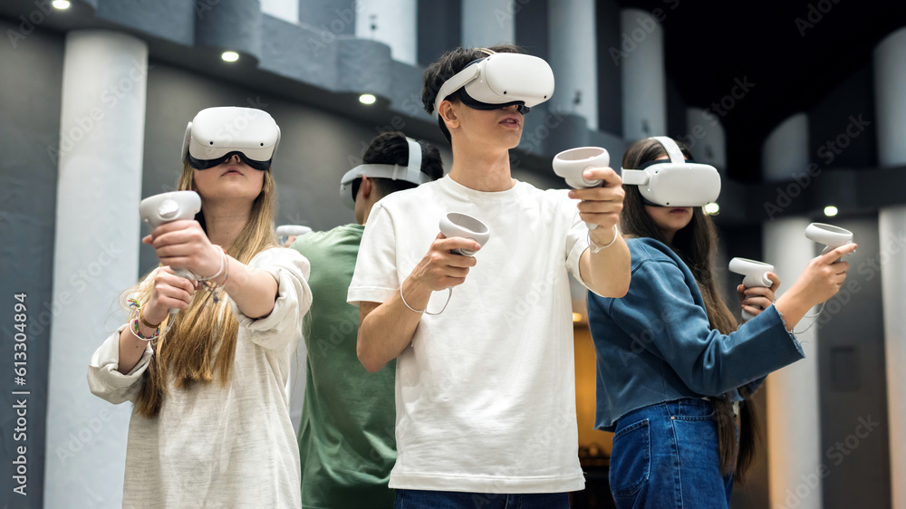 Four teenagers wearing VR equipment