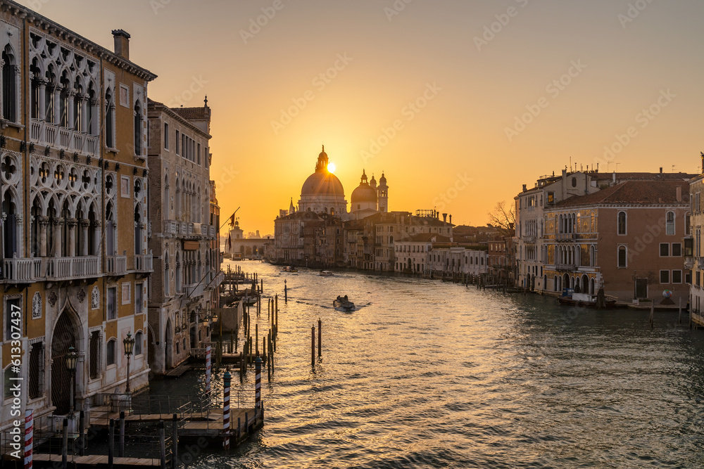 The Grand Canal in Venice with the silhouette of the Santa Maria della Salute basilica at sunrise, Italy, Europe.