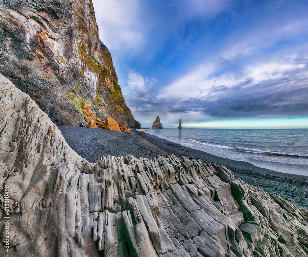 Gorgeous landscape with basalt rock formations Troll Toes on Black beach Reynisfjara near the village of Vik. Location: Reynisfjara Beach, Vik Village, Iceland (Sudurla