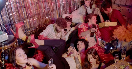 Group of people use phones during a fun party. The Influence of Mobile Phone Addiction on Procrastination. 