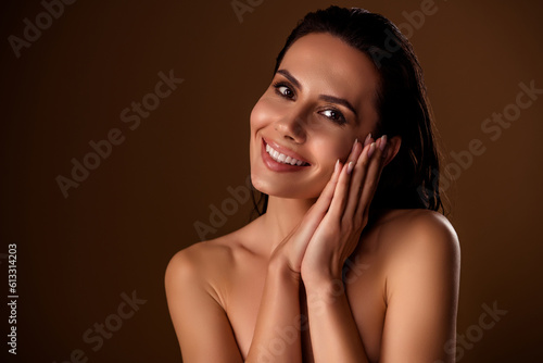 Photo of attractive woman model with wet hair hold arms near soft facial skin studio portrait isolated brown background