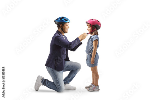 Father and daughter with helmets getting ready for a bicycle ride