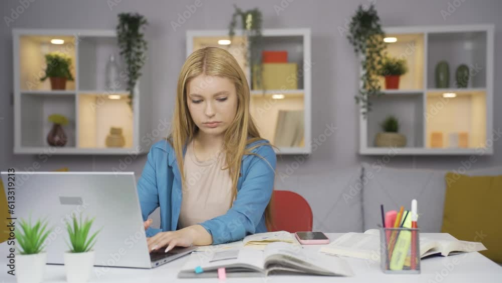 The Female student who finishes the homework is happy and peaceful. The Female student who finishes the homework is happy and peaceful.