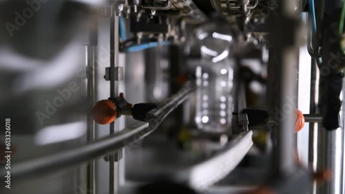 Production of plastic bottles. Plastic containers moving through the pipeline.