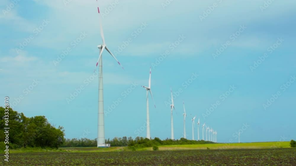 Wind turbines on green field in countryside, aerial view Wind turbines on green field in countryside, aerial view