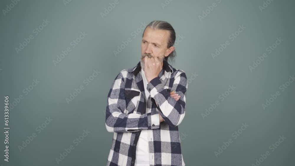 The man is biting his nails. The man is biting his nails.