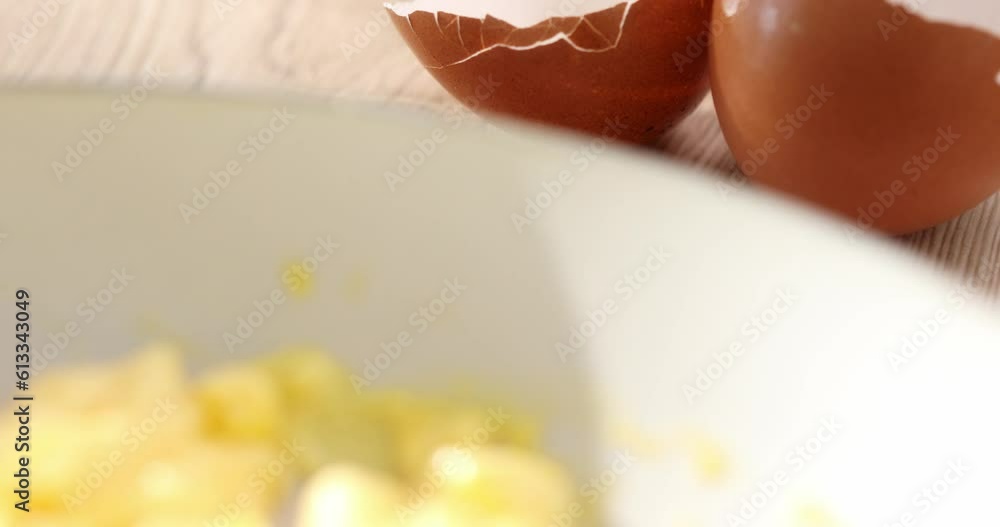 Scrambled eggs with milk into a frying pan. Making an omelet. Cooking traditional breakfast from eggs. Close up. Smooth camera movement. Sunny day. High quality 4k footage Scrambled eggs with milk into a frying pan. Making an omelet. Cooking traditional breakfast from eggs. Close up. Smooth camera movement. Sunny day. High quality 4k footage