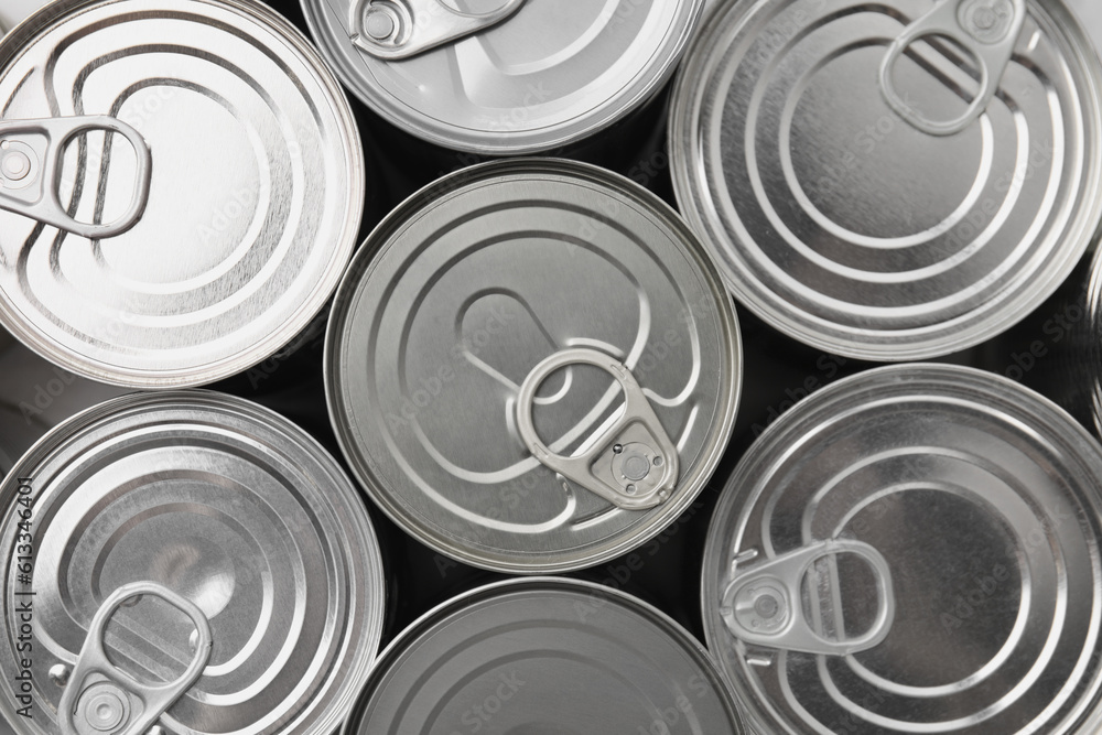 Many closed tin cans as background, top view Many closed tin cans as background, top view