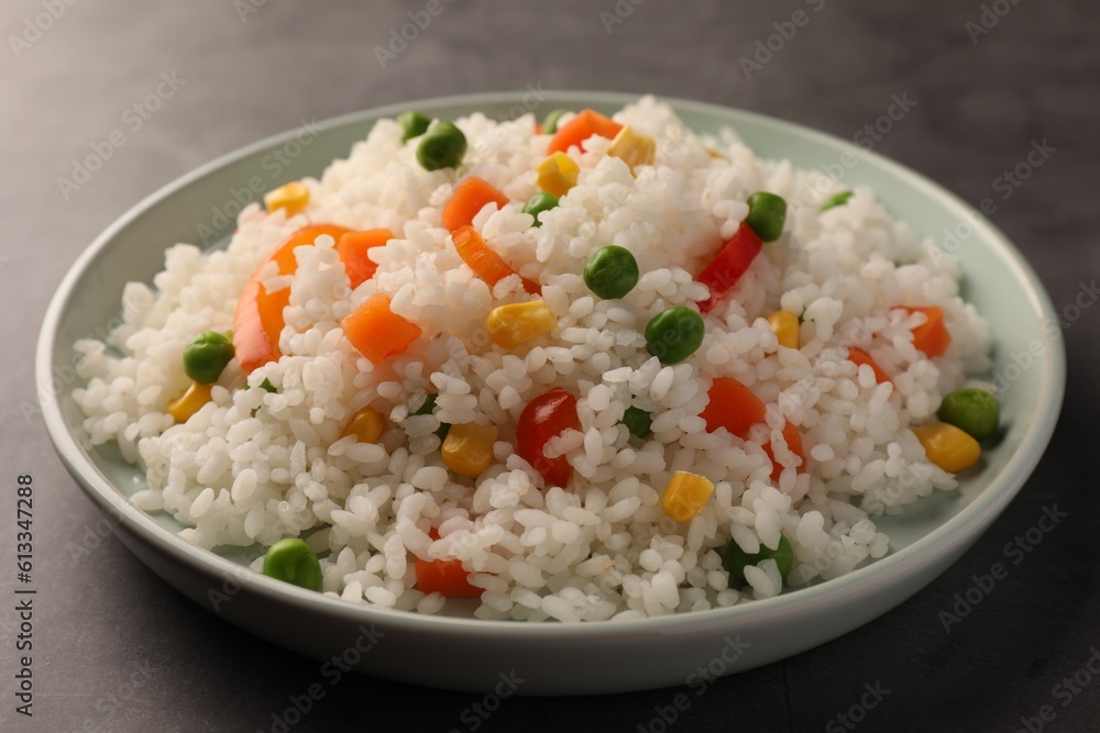 Delicious rice with vegetables on grey table, closeup Delicious rice with vegetables on grey table, closeup