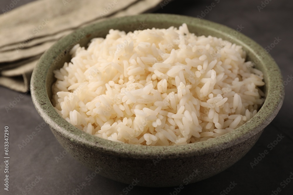 Delicious rice in bowl on grey table, closeup Delicious rice in bowl on grey table, closeup