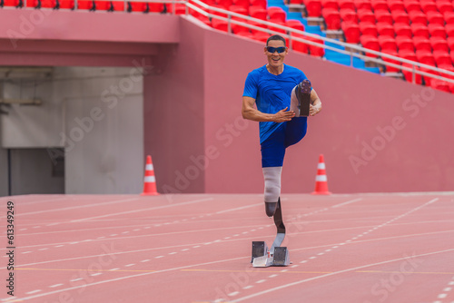 Male speed runner at stadium, warms up with high knee jump at the start block before race