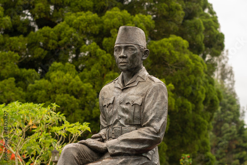 Indonesian Hero Statue Among Trees and Plants in Architectural Memorial Site