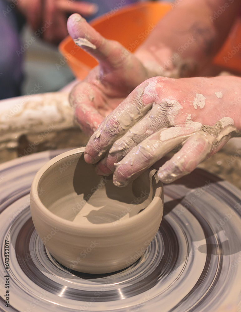 Pottery lesson master class for kids children, process of making clay pot on pottery wheel, potter wet hands creating ceramic crockery handcrafts, ceramist molding jar or vase