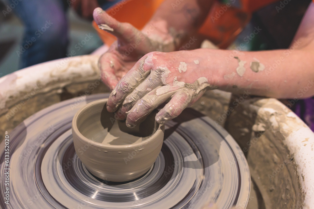 Pottery lesson master class for kids children, process of making clay pot on pottery wheel, potter wet hands creating ceramic crockery handcrafts, ceramist molding jar or vase Pottery lesson master class for kids children, process of making clay pot on pottery wheel, potter wet hands creating ceramic crockery handcrafts, ceramist molding jar or vase