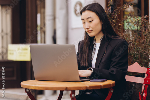 Business freelance young adult asian woman using laptop computer for work and talking by phone something. Sitting at outdoor on day. Urban people lifestyle with modern technology.