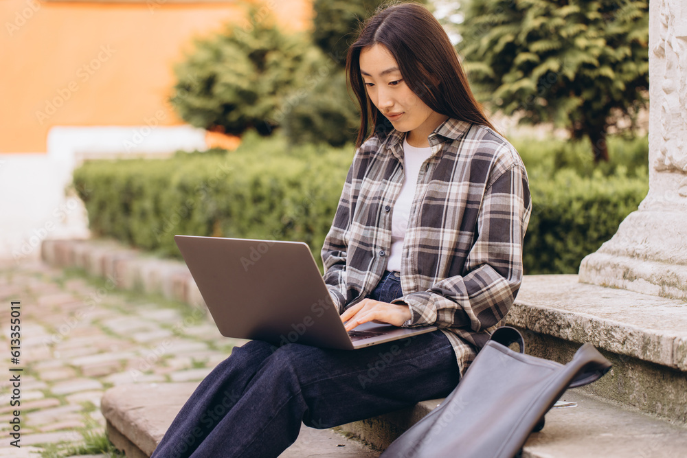 Freelance young adult asian woman using laptop computer for work. Sitting at outdoor on day. Urban people lifestyle with modern technology. Freelance young adult asian woman using laptop computer for work. Sitting at outdoor on day. Urban people lifestyle with modern technology.