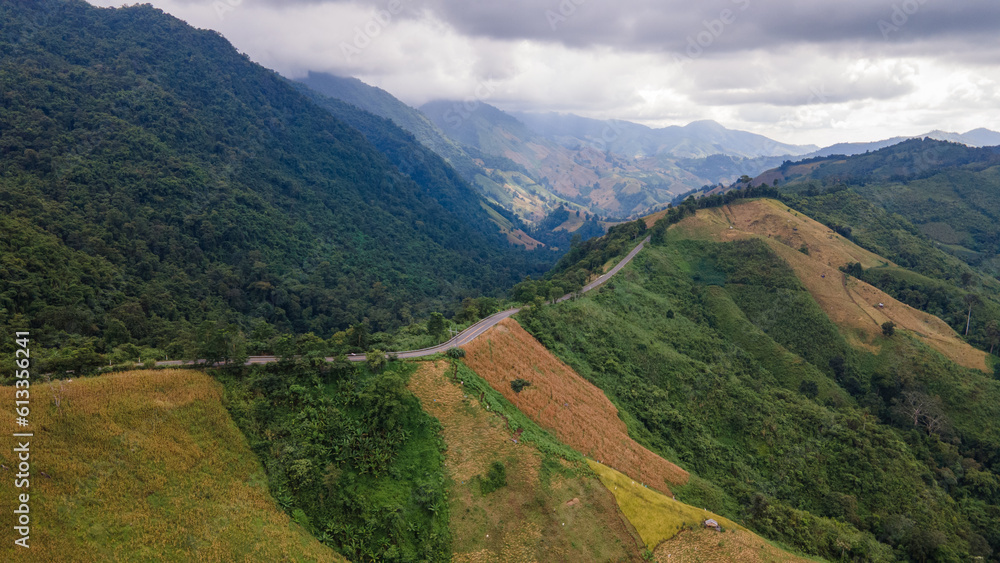 Shot from a drone camera angle at the Sky Road. Road 1256, Unseen Road, Nan Province, Thailand. It winds along the ridge of the forest. very beautiful view The rainy season will be green