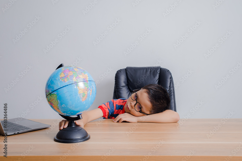 Asian boy looking at world map