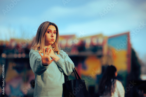 Fotografie Woman Making Stop Hand Sign Gesture in a Funfair