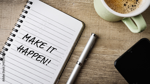 Make it happen! Flat lay. Work area with notepad, pen, cell phone and a cup of coffee. 