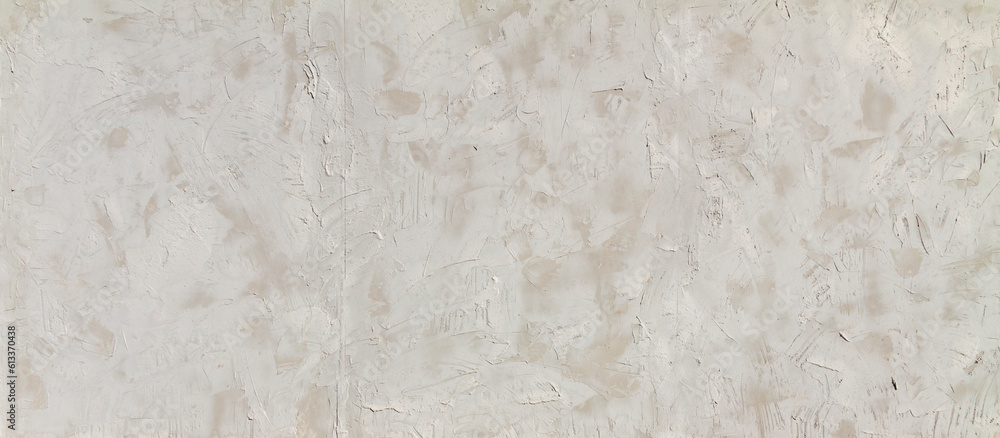 Obraz premium The alternating plastered walls of the building are covered with alternating layers of plaster and cement, creating a textured background for banners.