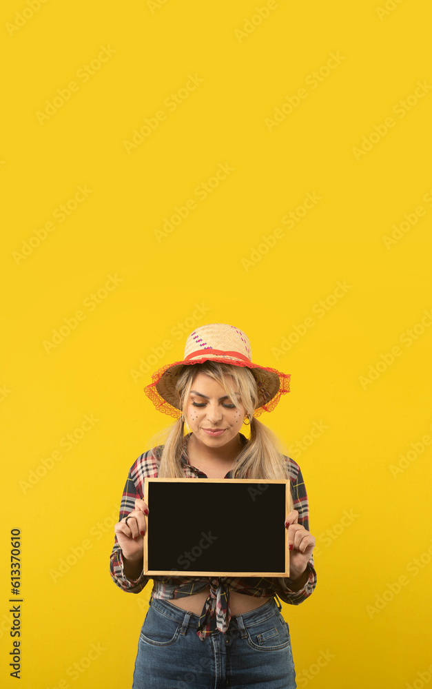 Beautiful brazilian woman, with festa junina clothes, on yellow background Beautiful brazilian woman, with festa junina clothes, on yellow background