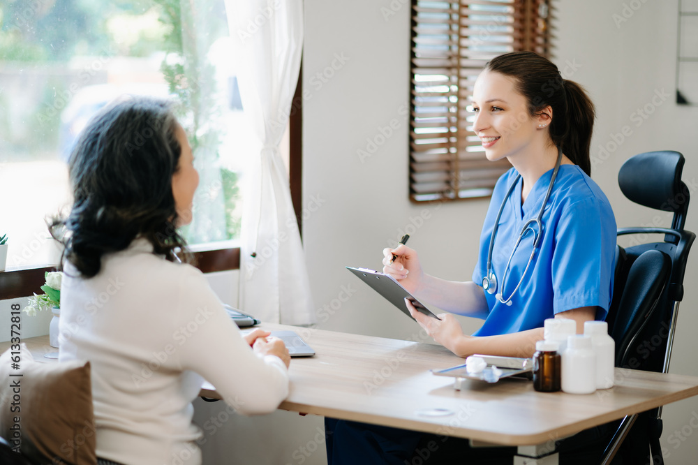 Medical doctor holing senior patient's hands and comforting her at home Medical doctor holing senior patient's hands and comforting her at home