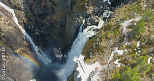 Drone flight over rainbow in mist by spectacular Vøringsfossen waterfall