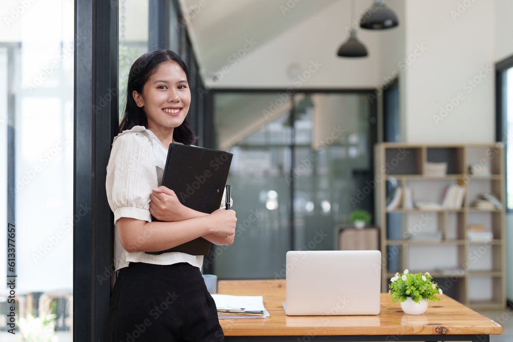 Financier a asian woman works, uses a laptop, makes a report to a finance company. Accounting and financial concept Financier a asian woman works, uses a laptop, makes a report to a finance company. Accounting and financial concept