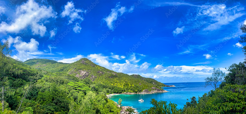 Panoramic view of Anse major nature trail, view of Anse major nature trail, ocean view, lush national park with granite rocks, turquoise ocean and docking yacht  Mahe Seychelles