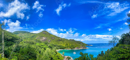 Panoramic view of Anse major nature trail, view of Anse major nature trail, ocean view, lush national park with granite rocks, turquoise ocean and docking yacht Mahe Seychelles