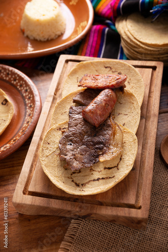 Taco campechano style, Carne Asada. (roast meat) and chorizo or longaniza, very popular dish in northern Mexico, also called Asado, Discada or Parrillada. photo