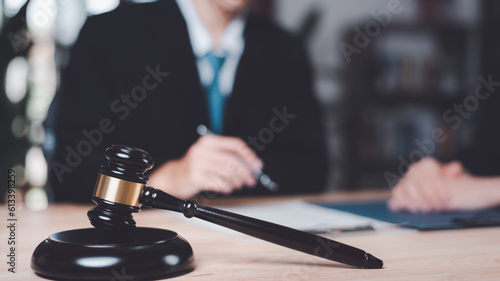Wooden judge gavel on table  justice in punishment of offenses and criminal verdicts  concept of law and justice  Lawyer or judge examining documents  legal contract consulting  court proceedings
