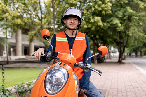 Photography Happy young Thai motorcycle taxi driver or rider waiting for passenger near by the building in the city