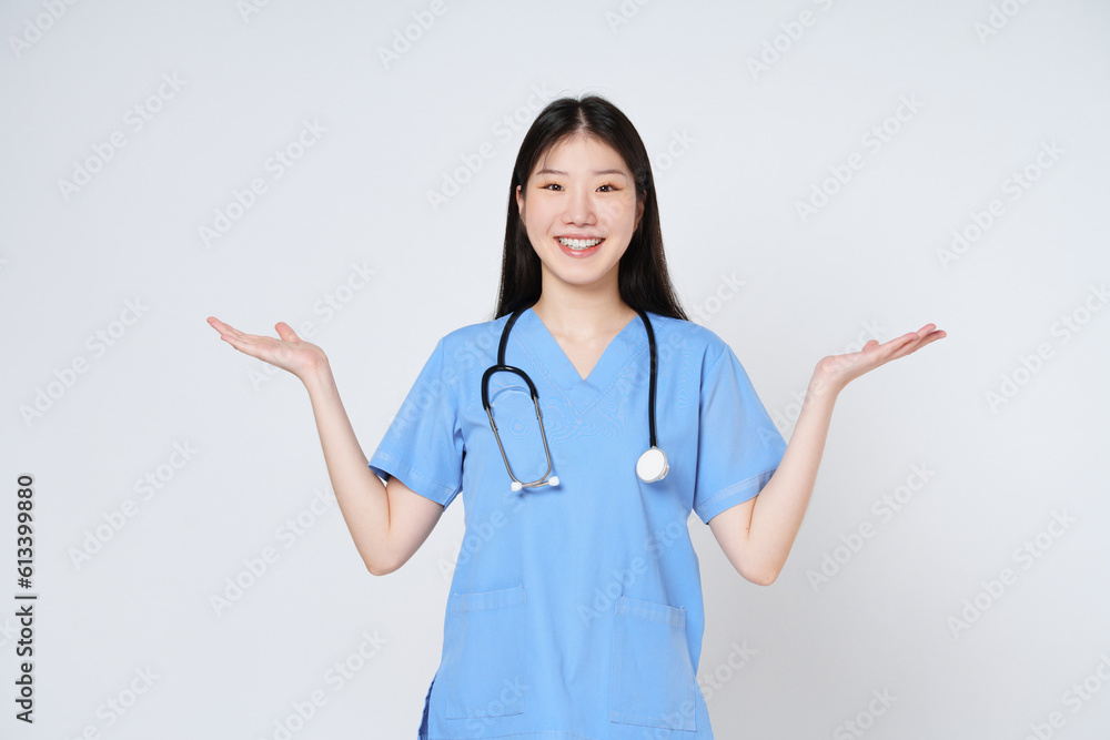 Young doctor woman wearing a stethoscope and showing open hand palm with copy space for product isolated on white background. Young doctor woman wearing a stethoscope and showing open hand palm with copy space for product isolated on white background.