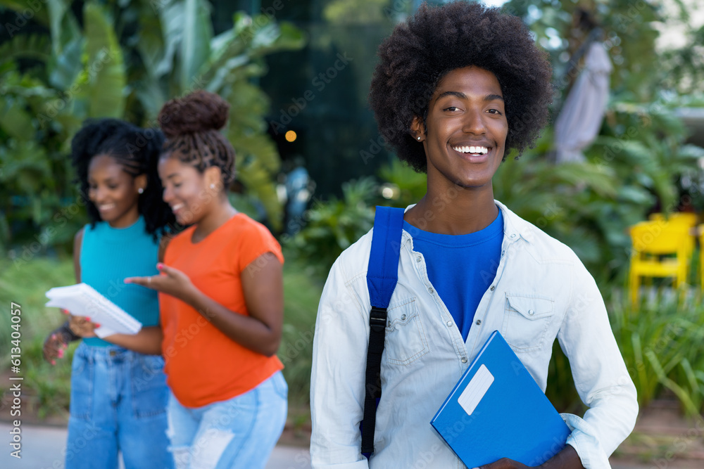 Handsome african american male student with group of black young adults ...