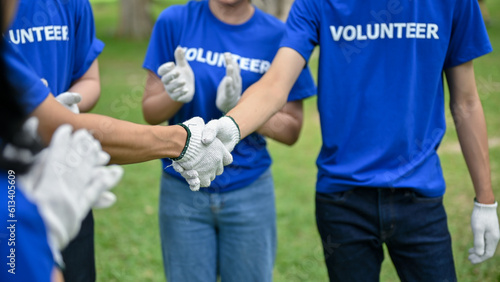 Close-up image of a male volunteer shakes hands with his team after finishing volunteer work